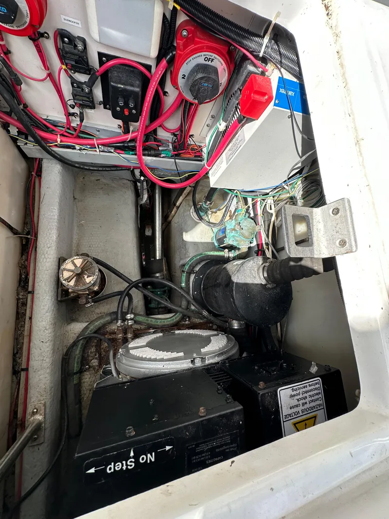 Slide: The Image of Engine compartment of a 1998 Mainship 350 Trawler with wiring and components visible. - 31