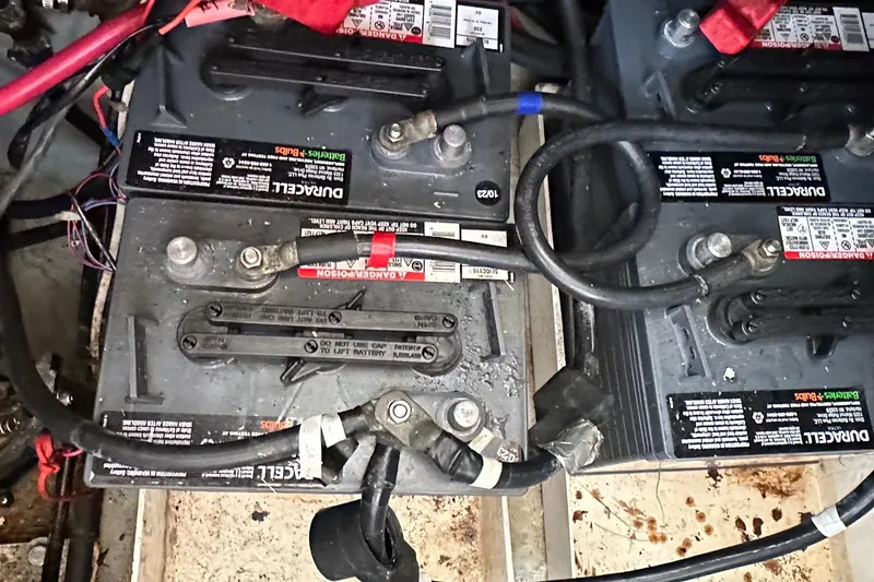Slide: The Image of Batteries in a 1998 Mainship 350 Trawler, showing wiring and connections. - 34