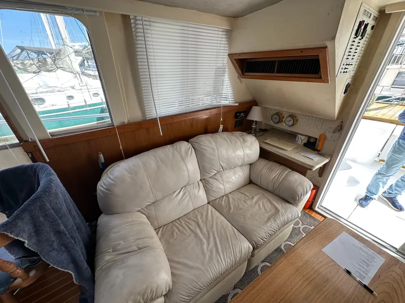 Slide: The Image of Interior of 1998 Mainship 350 Trawler with beige sofa and navigation station. - 46