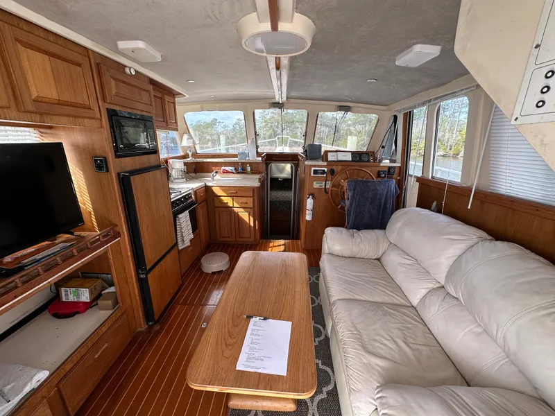 Slide: The Image of Interior of 1998 Mainship 350 Trawler with cozy seating, kitchen, and helm. - 47