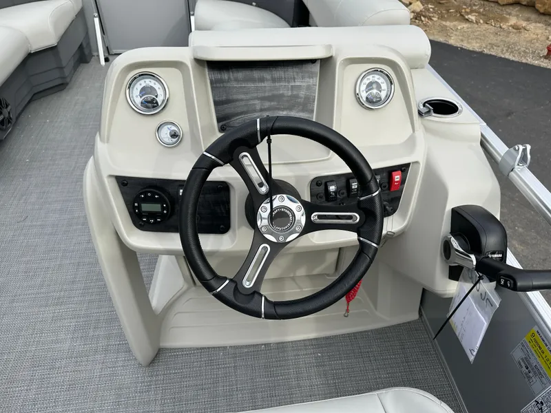 Slide: The Image of 2024 Starcraft LX 20 CB boat dashboard with steering wheel and controls. - 10