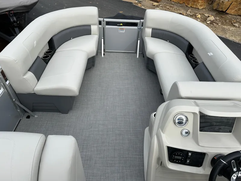 Slide: The Image of 2024 Starcraft LX 20 CB boat interior with gray seating and modern dashboard. - 12