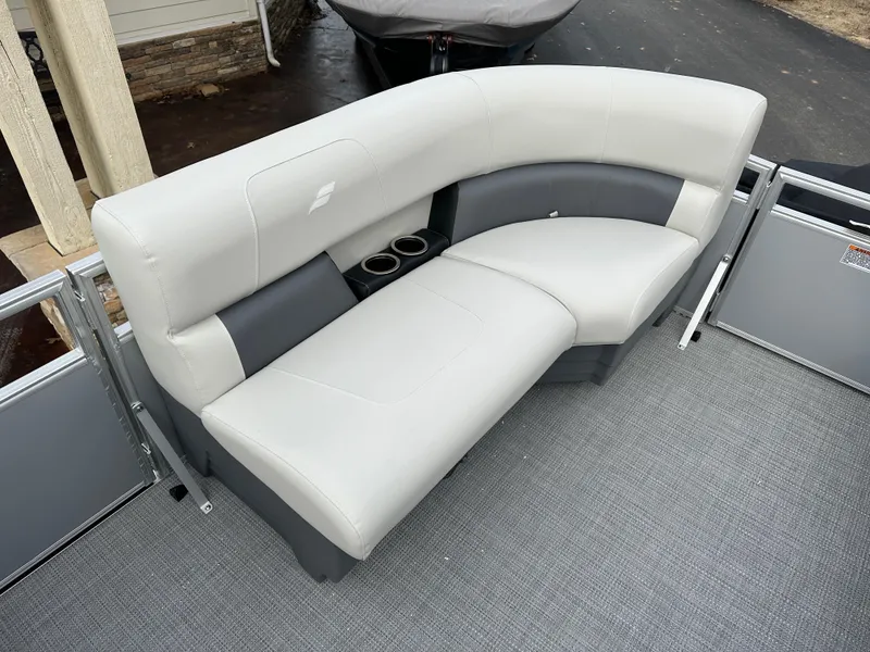 Slide: The Image of 2024 Starcraft LX 20 CB boat seating with cup holders, featuring sleek gray upholstery. - 14