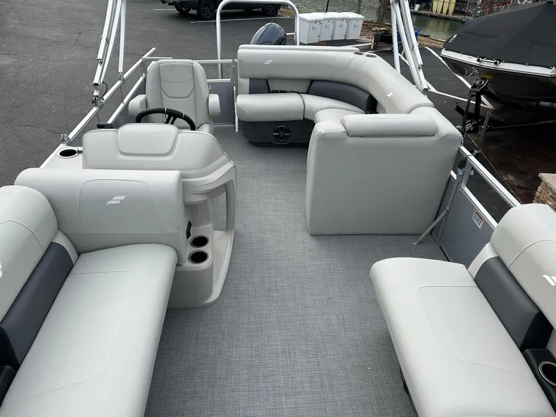 Slide: The Image of 2024 Starcraft LX 20 CB pontoon boat interior with gray seating and steering console. - 15