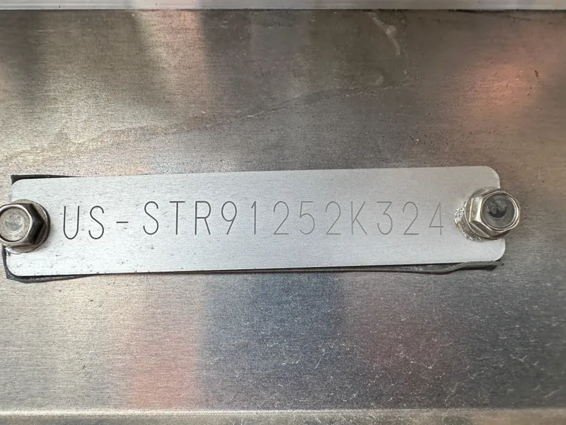 Slide: The Image of 2024 Starcraft LX 20 CB hull identification number plate with bolts. - 18