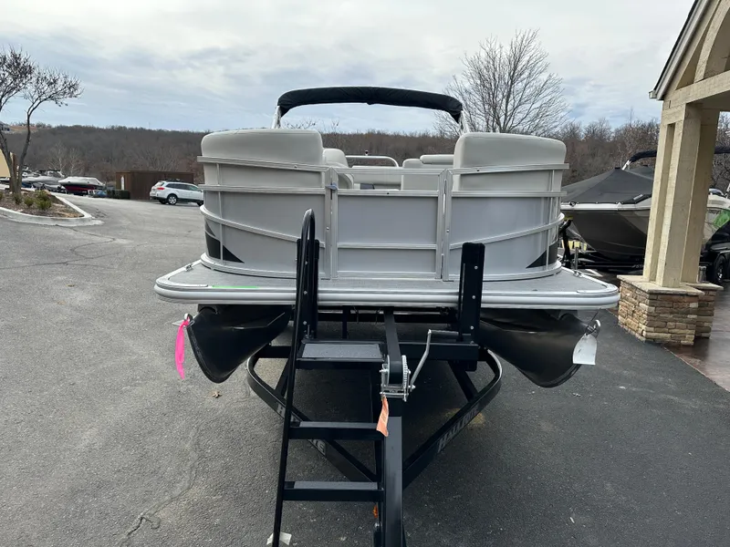 Slide: The Image of 2024 Starcraft LX 20 CB pontoon boat on trailer, parked outdoors. - 5