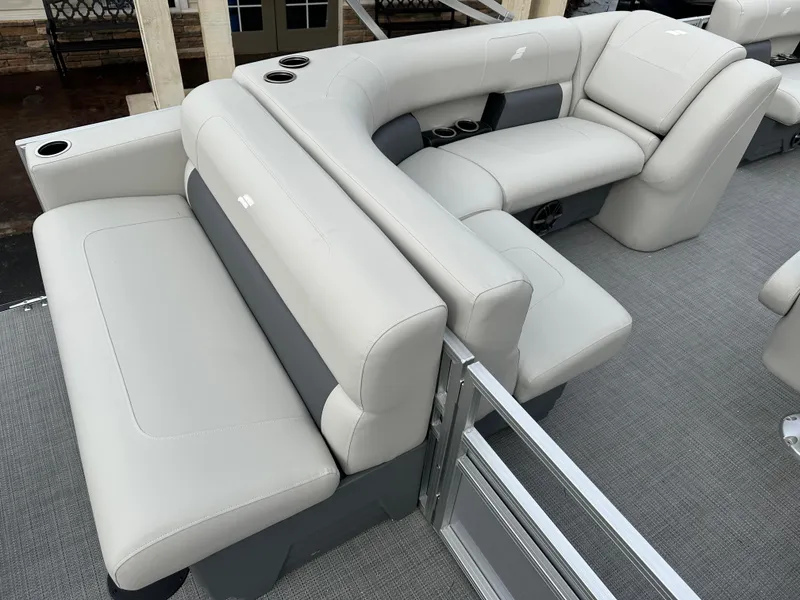 Slide: The Image of 2024 Starcraft LX 20 CB boat interior with plush seating and cup holders. - 7