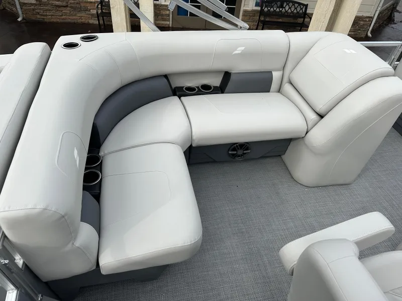 Slide: The Image of 2024 Starcraft LX 20 CB boat interior with plush gray seating and cup holders. - 8