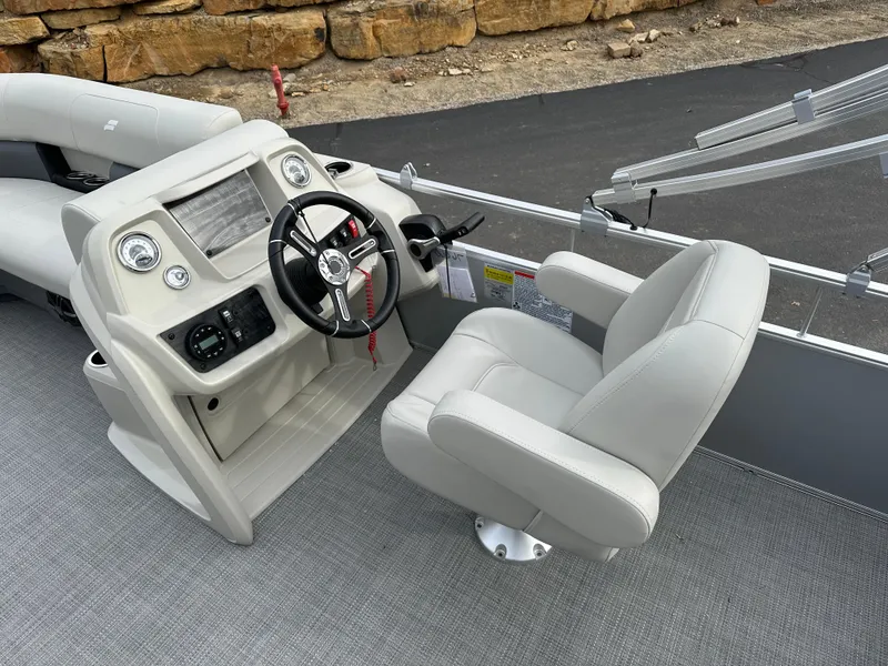 Slide: The Image of 2024 Starcraft LX 20 CB boat interior with steering console and captain's chair. - 9
