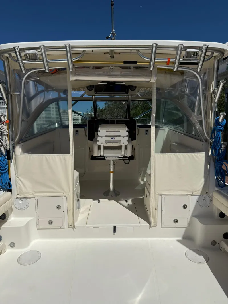 Slide: The Image of 2011 World Cat 320 EC boat interior with helm station and seating. - 17