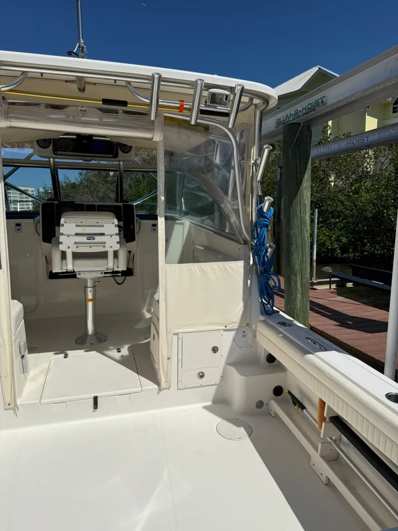 Slide: The Image of 2011 World Cat 320 EC boat interior with seating and fishing equipment. - 18