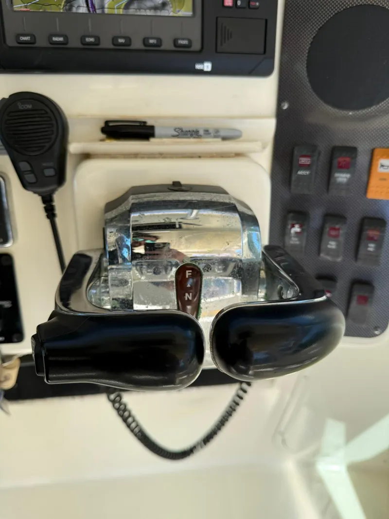 Slide: The Image of 2011 World Cat 320 EC boat controls and dashboard with throttle and switches. - 39