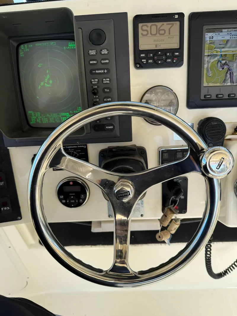 Slide: The Image of Steering wheel and dashboard of 2011 World Cat 320 EC boat with navigation instruments. - 40