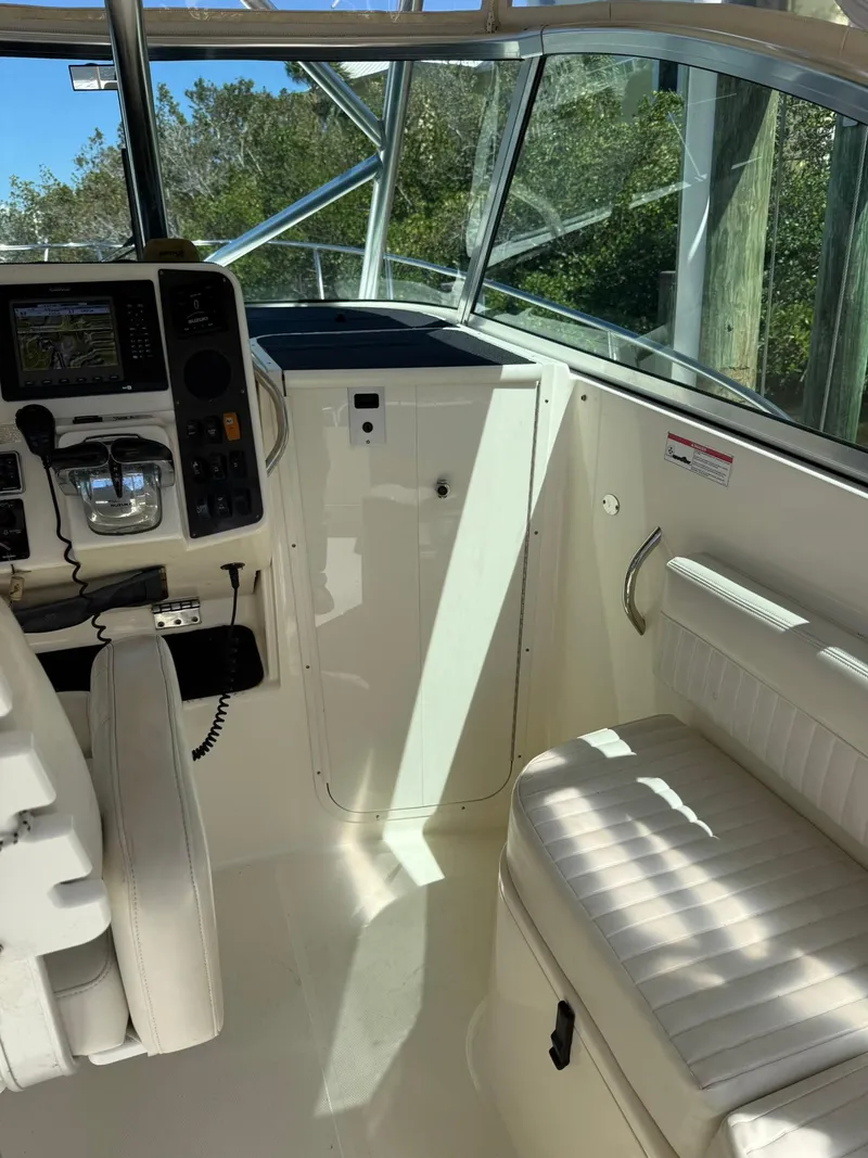 Slide: The Image of 2011 World Cat 320 EC boat interior with helm, seating, and navigation equipment. - 46