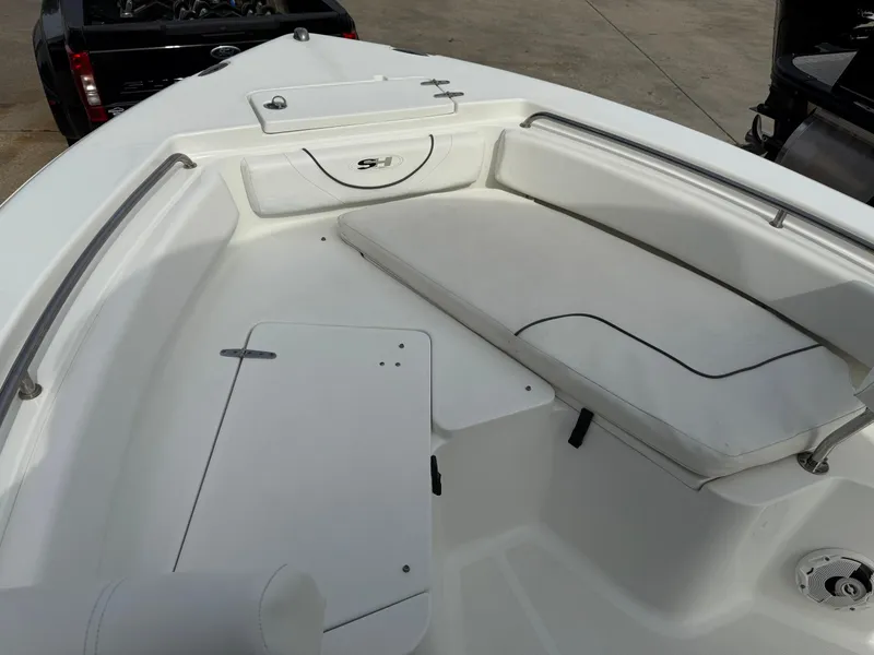 Slide: The Image of 2015 Sea Hunt 225 Ultra boat interior with white seating and storage compartments. - 3
