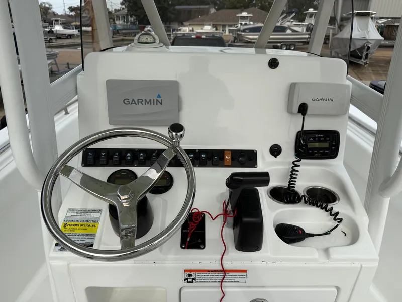 Slide: The Image of 2015 Sea Hunt 225 Ultra boat dashboard with Garmin navigation system and steering wheel. - 7