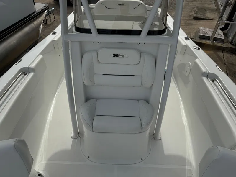 Slide: The Image of 2015 Sea Hunt 225 Ultra boat interior with white seating and console. - 9