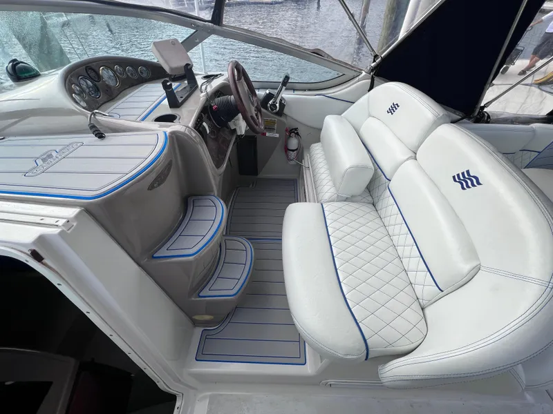 Slide: The Image of Interior of 2002 Four Winns 268 Vista boat with white seating and dashboard. - 10