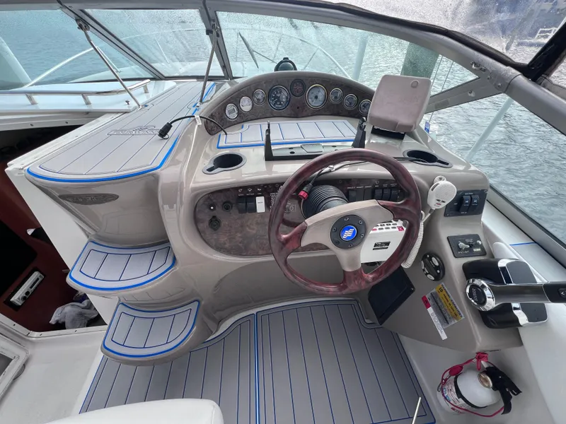 Slide: The Image of Cockpit of 2002 Four Winns 268 Vista with modern motor replacement, featuring steering wheel and controls. - 12