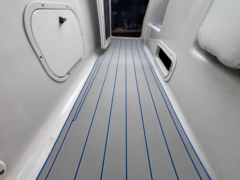 Slide: The Image of Interior view of a 2002 Four Winns 268 Vista boat with new flooring. - 17