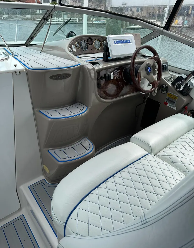 Slide: The Image of Interior of 2002 Four Winns 268 Vista with modern motor replacement, featuring plush seating and navigation. - 18