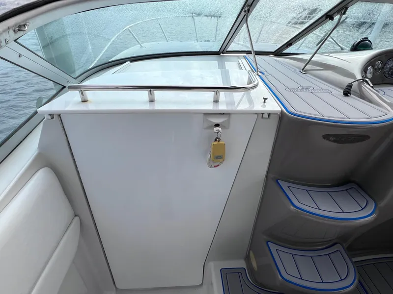 Slide: The Image of Interior view of a 2002 Four Winns 268 Vista boat, featuring modern helm and seating. - 20