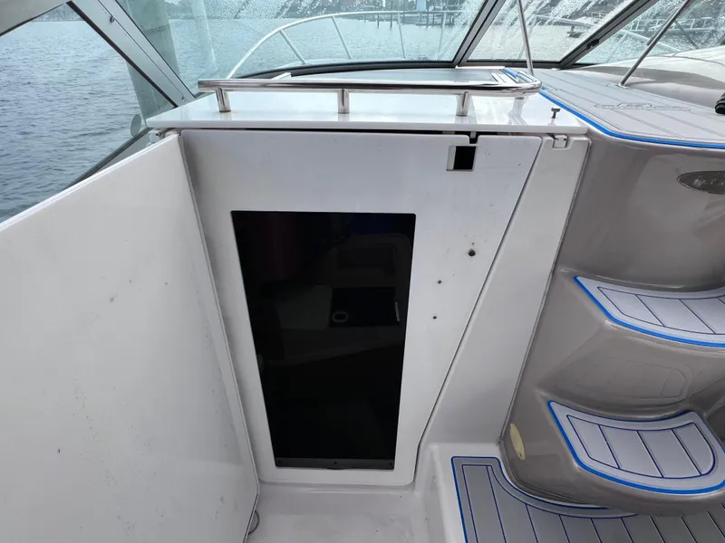 Slide: The Image of Interior view of 2002 Four Winns 268 Vista boat, featuring sleek design and modern motor replacement. - 21