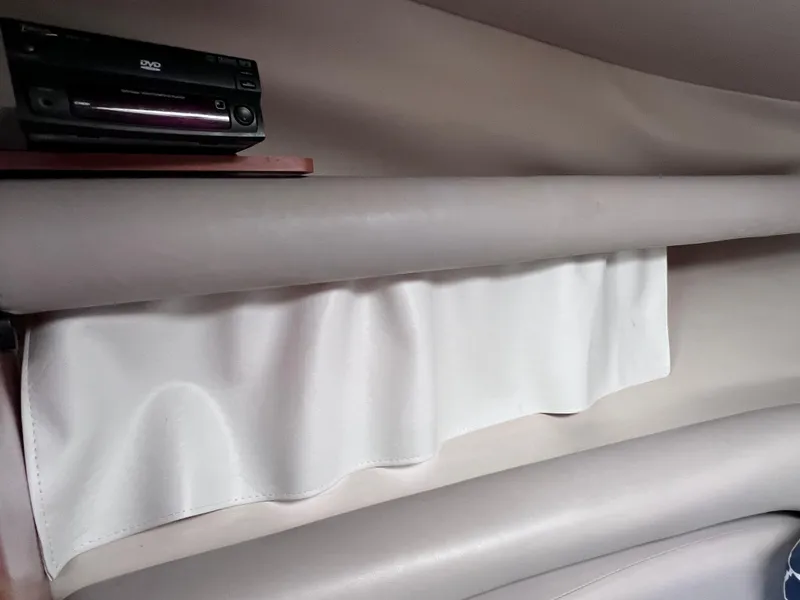 Slide: The Image of Interior of 2002 Four Winns 268 Vista with DVD player and white curtain. - 25