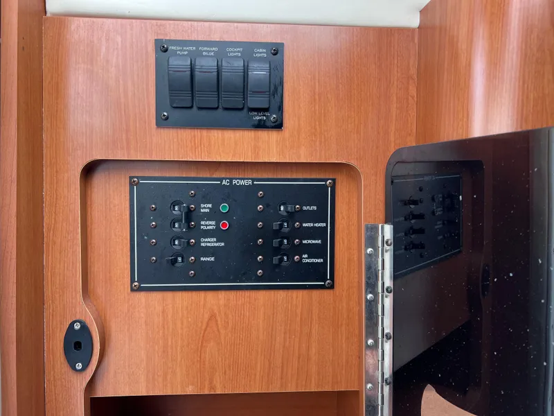 Slide: The Image of Electrical panel on a 2002 Four Winns 268 Vista boat, featuring AC power controls. - 29