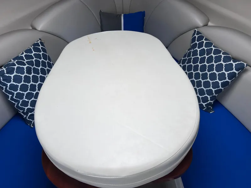Slide: The Image of Interior of 2002 Four Winns 268 Vista with cushioned seating and decorative pillows. - 31