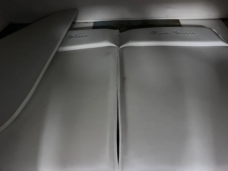 Slide: The Image of Cushioned seating of 2002 Four Winns 268 Vista boat, showcasing motor replacement area. - 32