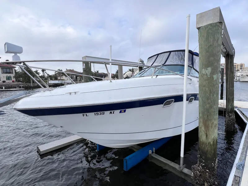 Slide: The Image of 2002 Four Winns 268 Vista boat docked, featuring 2023 motor replacement. - 4