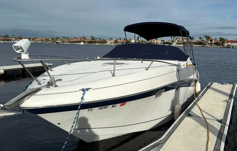 Slide: The Image of 2002 Four Winns 268 Vista boat docked, featuring 2023 motor replacement. - 5