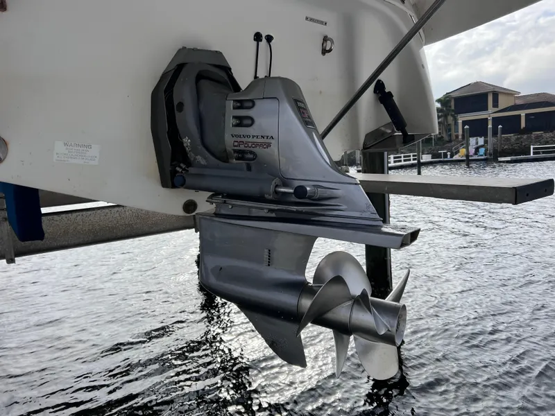 Slide: The Image of Outboard motor of a 2002 Four Winns 268 Vista, replaced in 2023, near water. - 7