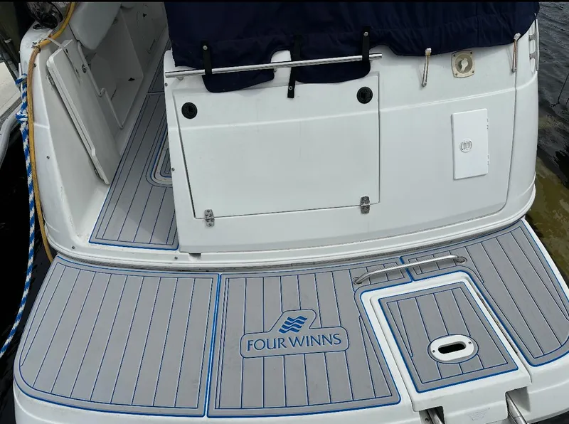 Slide: The Image of Four Winns 268 Vista 2002 boat deck with logo and motor replacement area. - 8