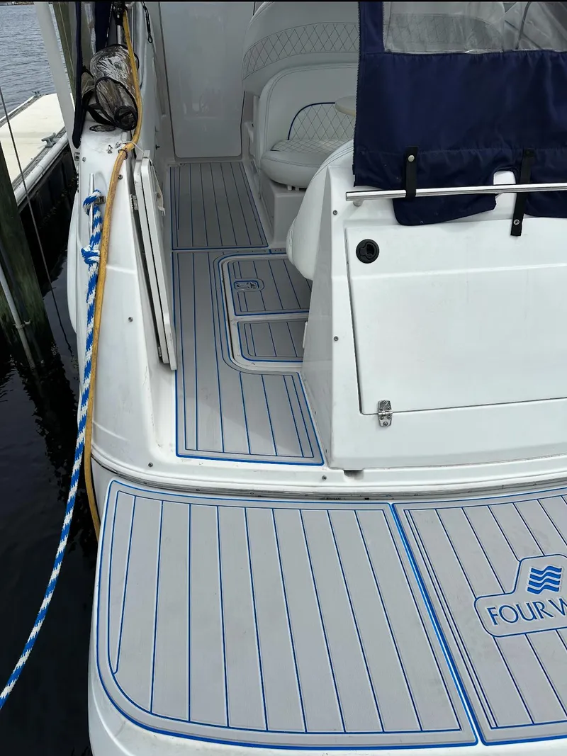 Slide: The Image of Four Winns 268 Vista boat deck, 2023 motor replacement, sleek design, docked. - 9