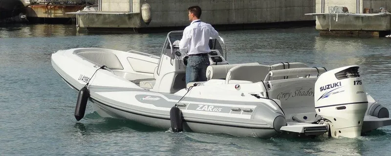 Slide: The Image of Zar Formenti 65 Suite 2025 boat with Suzuki engine on calm water. - 16