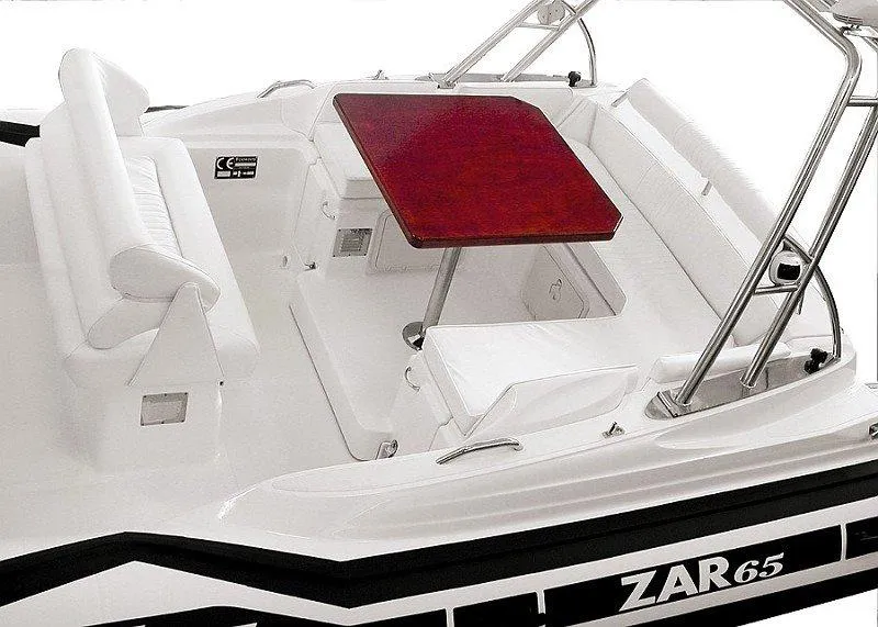 Slide: The Image of Zar Formenti 65 Suite 2025 boat interior with red table and white seating. - 21