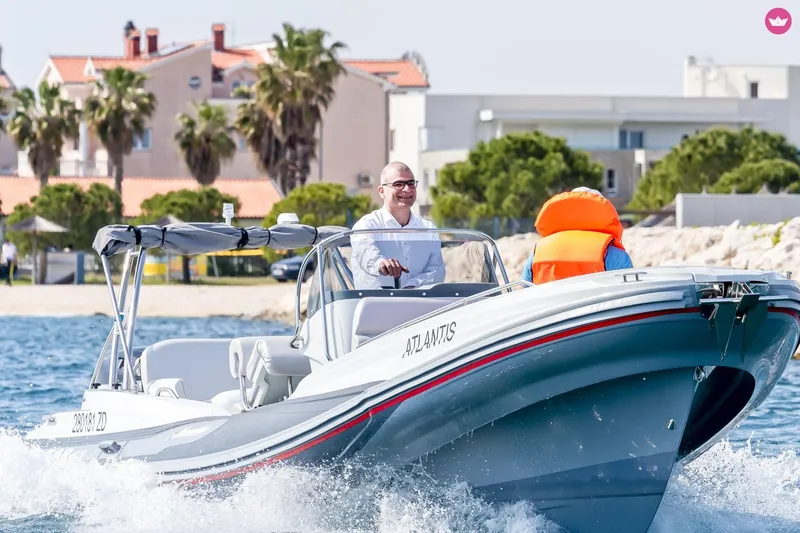 Slide: The Image of Man piloting Zar Formenti 65 Suite boat on sunny day, coastal backdrop, 2027 model. - 3