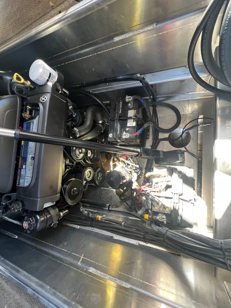 Slide: The Image of Engine compartment of a 2016 Bennington 2552 QCW I/O boat, showcasing mechanical components. - 16