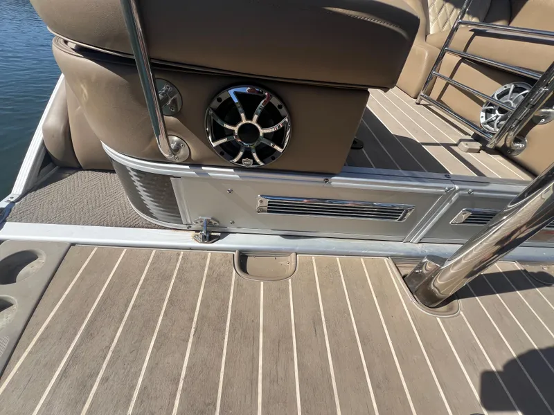 Slide: The Image of 2016 Bennington 2552 QCW I/O boat interior with speaker and seating detail. - 21