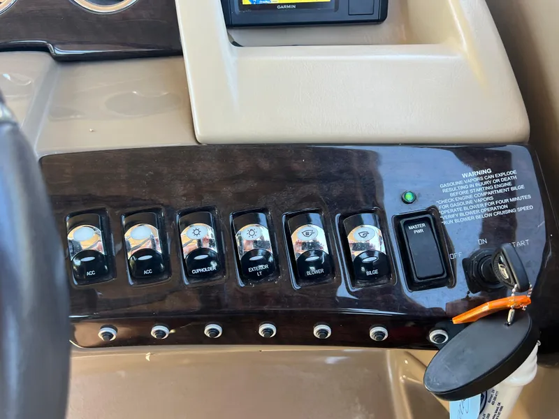 Slide: The Image of Control panel of a 2016 Bennington 2552 QCW I/O boat with switches and ignition. - 26