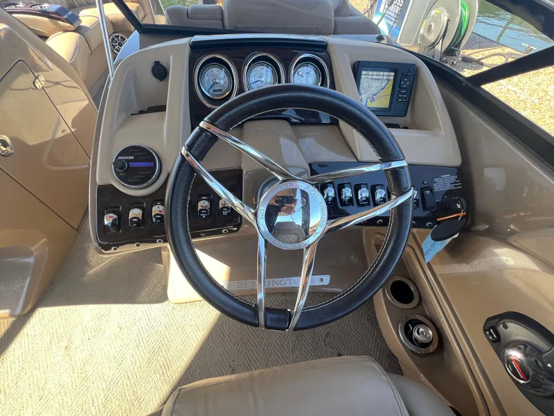 Slide: The Image of 2016 Bennington 2552 QCW I/O boat dashboard with steering wheel and control panel. - 29
