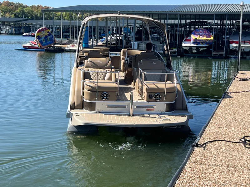 Slide: The Image of 2016 Bennington 2552 QCW I/O boat docked at marina, rear view. - 8