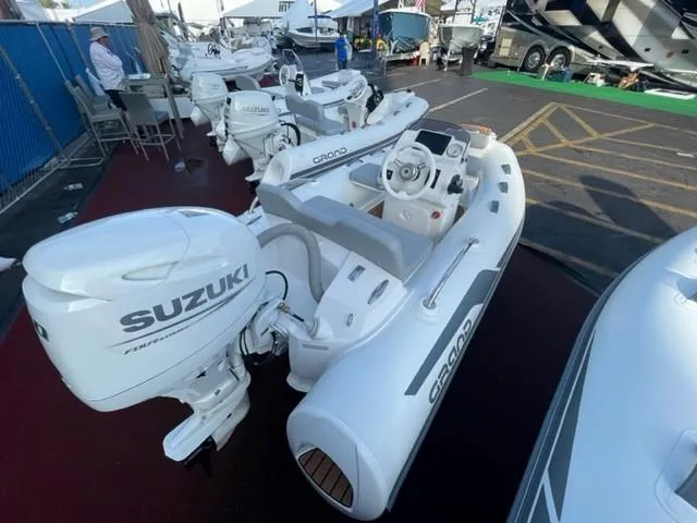 Slide: The Image of 2025 Grand Inflatables G340 boat with Suzuki outboard motor displayed at a marine exhibition. - 8