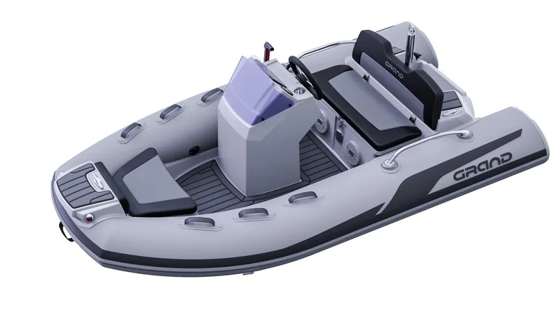 Slide: The Image of 2025 Grand Inflatables G380 boat, sleek design, gray color, modern seating, and control console. - 10