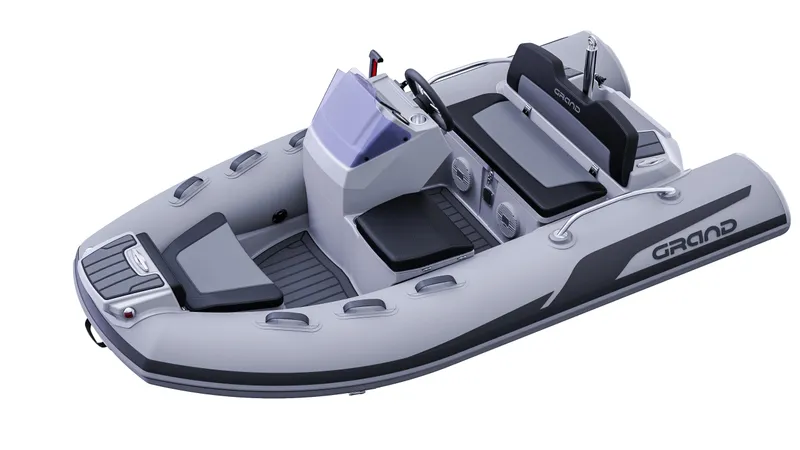 Slide: The Image of 2025 Grand Inflatables G380 boat, sleek design, gray color, modern seating, and control console. - 11