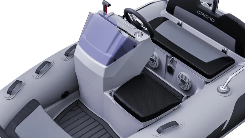 Slide: The Image of 2025 Grand Inflatables G380 boat interior with steering console and seating. - 12