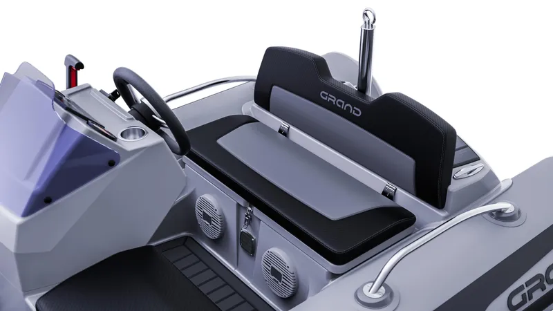Slide: The Image of 2025 Grand Inflatables G380 boat interior with steering wheel and seating. - 14