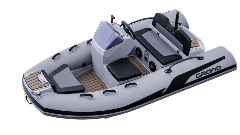 Slide: The Image of 2025 Grand Inflatables G380 boat, sleek design, gray with black accents, modern seating. - 8